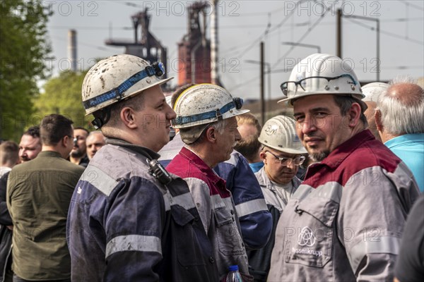 Steelworkers at a demonstration in front of the headquarters of ThyssenKrupp Steel Europe in Duisburg, against massive job cuts, after the participation of a foreign investor in the group, in the background the blast furnaces 8 and 9, Duisburg North Rhine-Westphalia, Germany, Europe