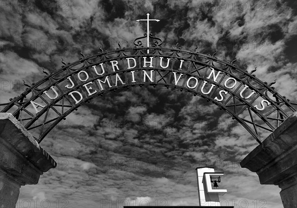 Wrought-iron portal by Francois Theis with the inscription Heute Ihr Morgen Wir, entrance to the cemetery in Consdorf, Duchy of Luxembourg