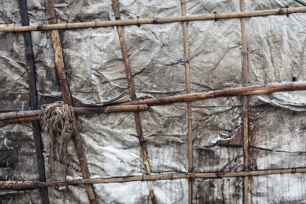 Detail of a makeshift dwelling made of plastic sheeting and bamboo sticks, Tejgaon Slum Area, Dhaka, Bangladesh, Asia