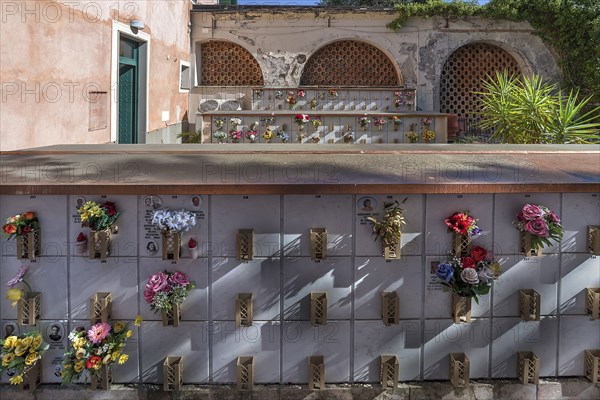 Flower-decorated urn graves in an inner courtyard, Monumental Cemetery, Cimitero monumentale di Staglieno), Genoa, Italy, Europe