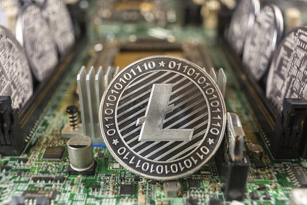 Litecoin close-up on a computer circuit motherboard as a blockchain technology payment network. Digital cryptocurrency concept and mining