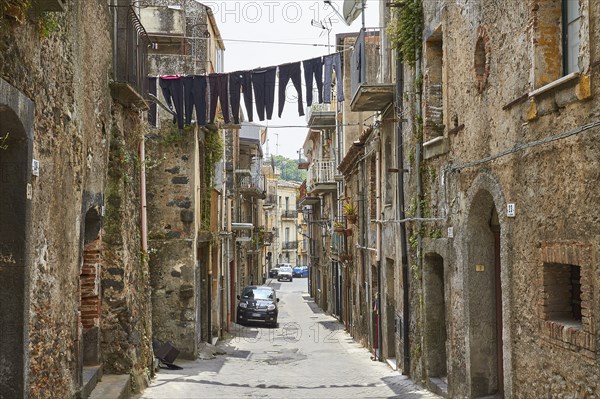 Narrow street in old town, empty, clothesline with laundry over the street, Randazzo, town, Nebrodi National Park, Sicily, Italy, Europe