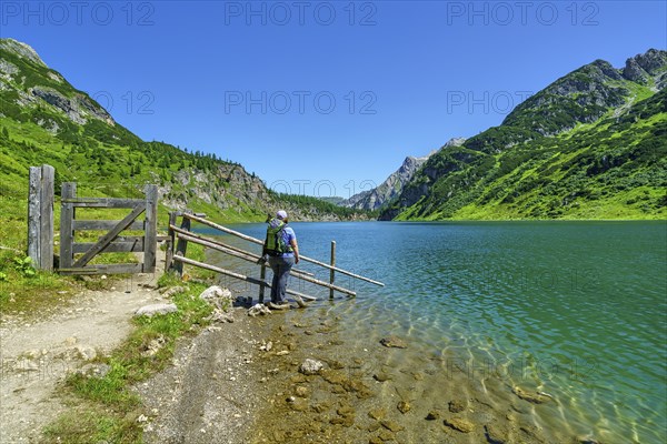 Hiker at Tappenkarsee, mountain lake, Radstätter Tauern, landscape conservation area, Kleinarl, Pongau, Salzburg