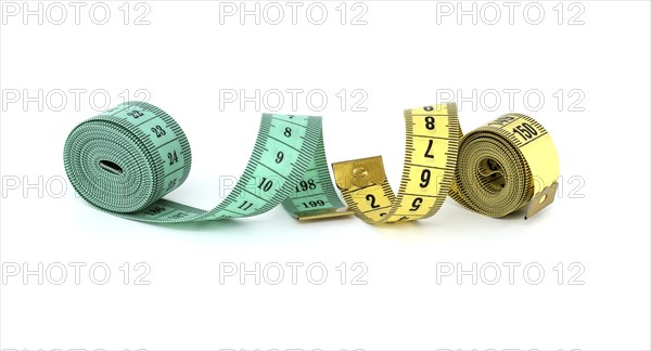 Yellow and green tape measure spirals creates a visual impression of motion isolated on white background