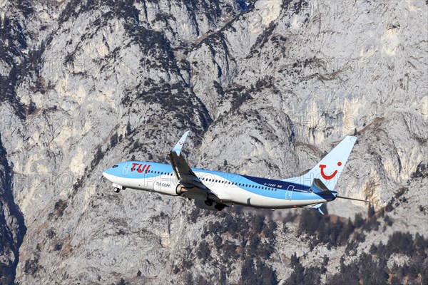 TUI airline aircraft taking off at Innsbruck Kranebitten Airport, Boeing 737-800. Snow-covered mountains of the Alps, Innsbruck, Tyrol, Austria, Europe