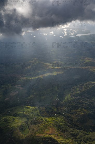 Aerial of sun breaking through the clouds over the volcanic landscape, Viti Levu, Fiji, South Pacific, Oceania