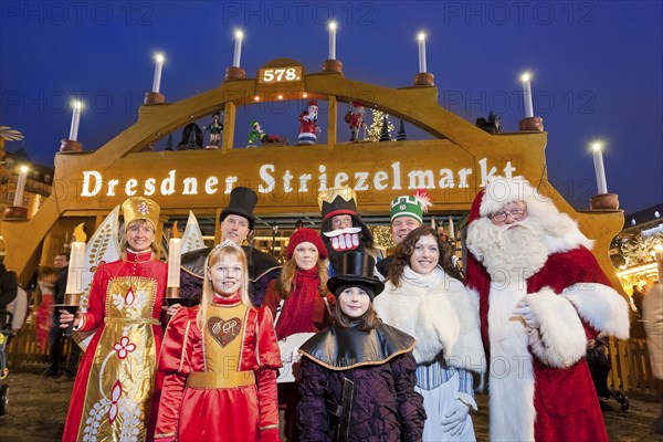 (Copyright Â© www.dresden-fotografie.de) (Sylvio Dittrich) (+49 1772156417) 578. Striezelmarkt 2012, the traditional figures in front of the world's largest walk-in candle arch. Angel with lights, gingerbread princess, big plum potato, Striezelkin, small plum potato, nutcracker, Stollen girl, miner and Father Christmas