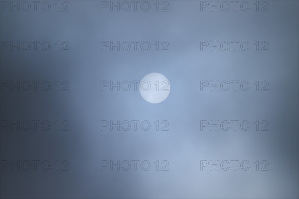 Moon shining through clouds at evening, Bavaria, Germany, Europe