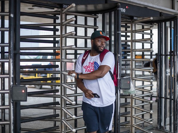 Sterling Heights, Michigan, Turnstiles greet auto workers entering or leaving Stellantis' Sterling Heights Assembly Plant. One worker leaves the plant, which makes the Ram 1500 truck, after an overnight shift