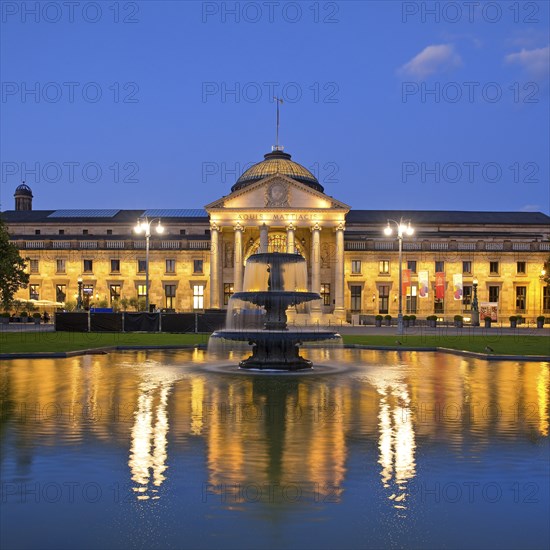 Illuminated spa hotel and Casino in the evening with cascade fountain, Wiesbaden, Hesse, Germany, Europe