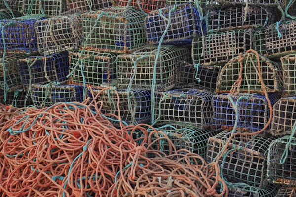 Lobster cages, lobster pots, here in Portugal, Algarve, Stacked fishing nets and ropes in different colours and textures, creating a chaotic yet vibrant atmosphere