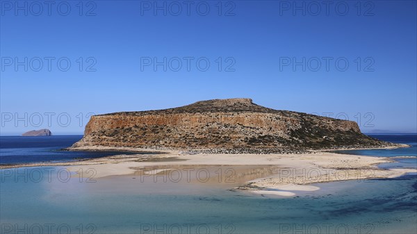 Rocky island with sandbank surrounded by clear blue sea under a cloudless sky, Gramvoussa, Gramvoussa Peninsula, Pirate Bay, Balos, Lagoon, Northwest Crete, Crete, Greek Islands, Greece, Europe