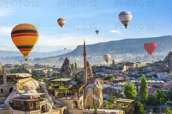 Ballooning over mosque in Goreme at sunrise, Cappadocia