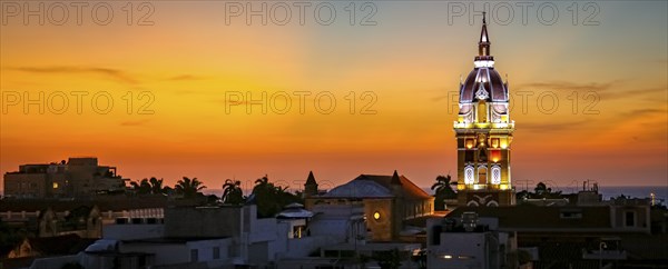 Wonderful view after sunset over Cartagena with illuminated Cartagena Cathedral against orange-yellow sky