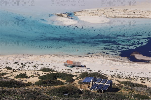 Caretaker building, Secluded beach with blue water and solar panels on the coast, Quiet and peaceful atmosphere, Gramvoussa, Gramvoussa Peninsula, Pirate Bay, Balos, Lagoon, Northwest Crete, Crete, Greek Islands, Greece, Europe