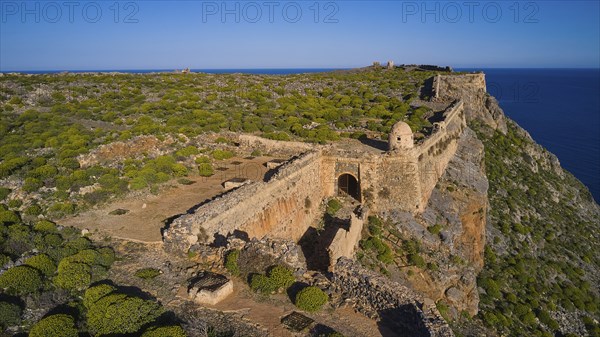 Drone shot, An ancient fortress ruin running along an overgrown cliff overlooking the sea, Venetian sea fortress, Gramvoussa, Gramvoussa peninsula, Pirate Bay, Balos, Lagoon, Northwest Crete, Crete, Greek Islands, Greece, Europe