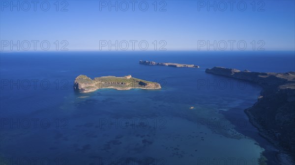 Drone shot, aerial view of an island with green area surrounded by blue sea and steep cliffs, Gramvoussa, Gramvoussa peninsula, Pirate Bay, Balos, lagoon, north-west Crete, Crete, Greek Islands, Greece, Europe