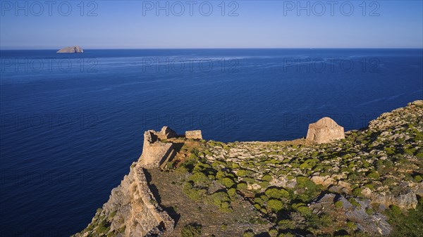 Drone shot, A historic ruin on a cliff overlooking the blue Mediterranean Sea to the horizon, Venetian sea fortress, Gramvoussa, Gramvoussa Peninsula, Pirate Bay, Balos, Lagoon, Northwest Crete, Crete, Greek Islands, Greece, Europe