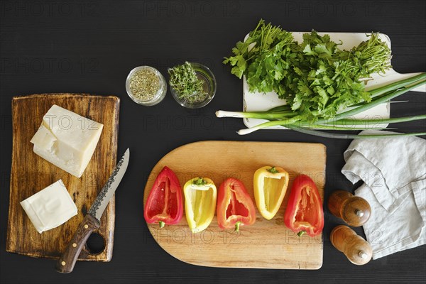 Overhead view of ingredients for baking peppers with goat cheese and mozzarella on the table