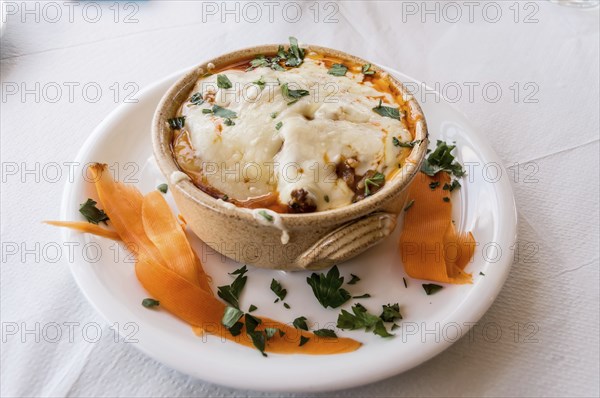 Veal ramequin au gratin with feta cheese with Greek pasta