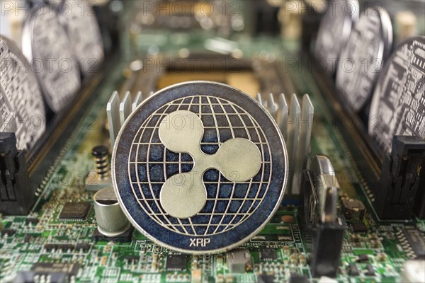 Ripple coin close-up on a computer circuit motherboard as a blockchain technology payment network. Digital cryptocurrency concept and mining