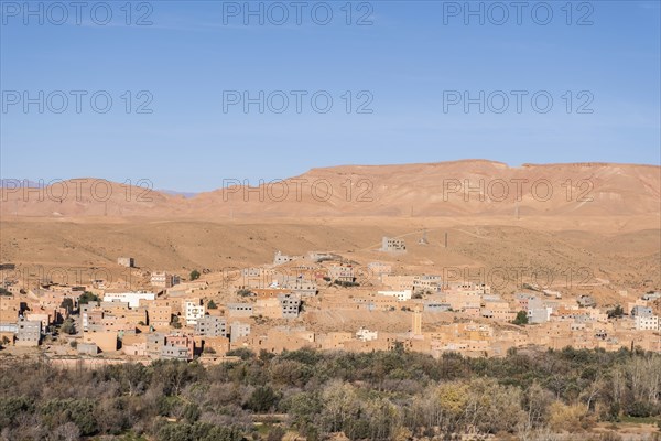 A panoramic view of a city in the Atlas Mountains, with its ancient medina, fortress walls, and picturesque harbor