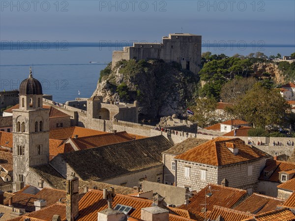 View of a town with red tiled roofs and a castle on the coast, dubrovnik, Mediterranean Sea, Croatia, Europe