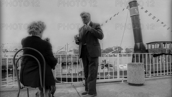 Germany, Berlin, 27.06.1991, landing stage of the Weiße Flott e in Treptower Park, woman on chair, dachshund, old steamer, Europe