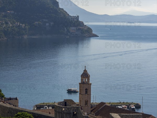 Historic bell tower with a picturesque coastal landscape and mountains in the background, Dubrovnik, Mediterranean Sea, Croatia, Europe