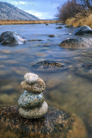 A rock cairn is on a wet rock in the Salmon River near Stanley, Idaho