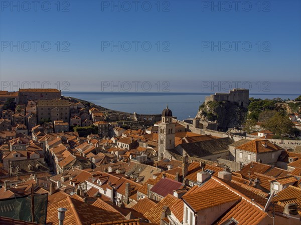 Panorama of a city with red tiled roofs and a castle by the sea, dubrovnik, Mediterranean Sea, Croatia, Europe