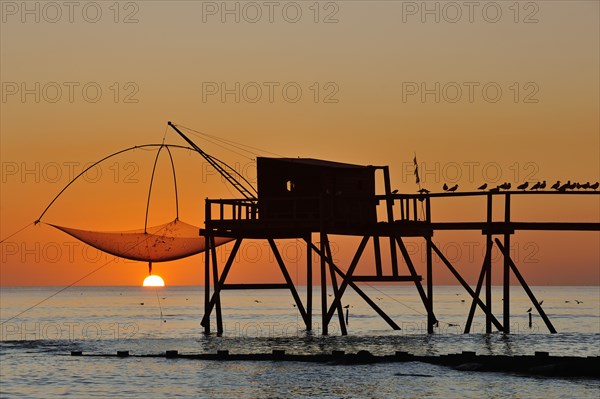 Traditional carrelet fishing hut with lifting net on the beach at sunset, Loire-Atlantique, Pays-de-la-Loire, France, Europe