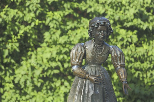 Sculpture and figure as a woman with Biedermeier clothing at the Datterich fountain at Luisenplatz, Darmstadt, Bergstrasse, Hesse, Germany, Europe