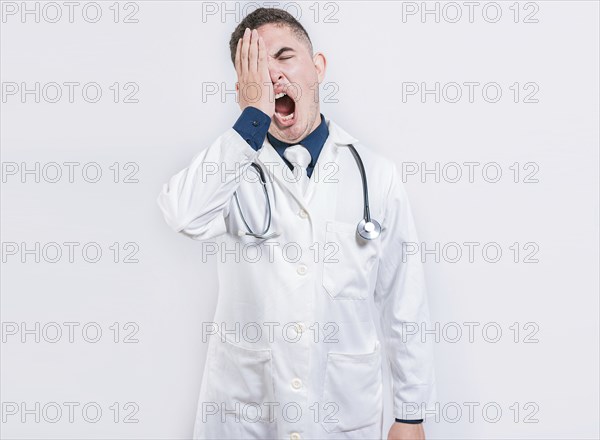 Sleepy doctor yawning on isolated background. Tired of working doctor concept, Tired and sleepy doctor isolated