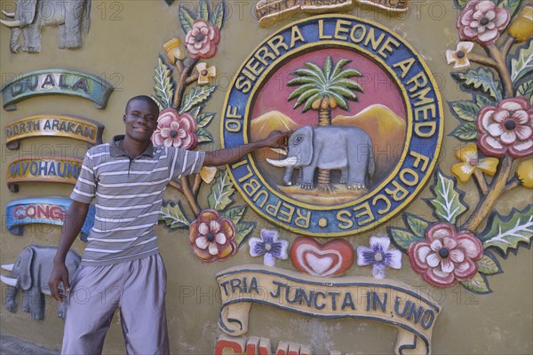 Tour guide standing at the Sierra Leone Peace and Cultural Monument, Freetown, Sierra Leone, Africa