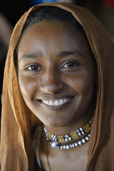 Young girl from a nomadic tribe, wearing headgear, portrait, Bayuda Desert, in Karima, Nubia, Northern Sudan, Sudan, Africa