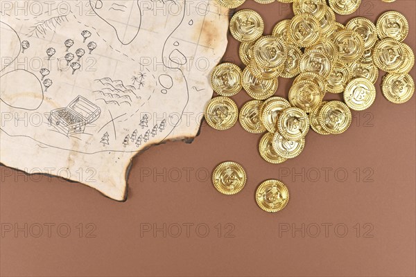 Hand drawn pirate treasure map with toy gold coins for children