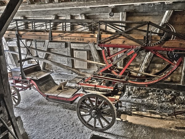 Old style slightly alienated photo of Historic fire engine for horse-drawn carriage from early 20th century with turntable ladder inscription Oberndorf 1911, Open Air Museum Neuhausen, Neuhausen ob Eck, Baden-Württemberg, Germany, Europe