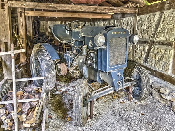 In old sil photographed historical tractor Deutz type F1M 414-46 11-series 1-cylinder year of construction 1946 in unrestored condition in historical storage place in farm in open-air museum Neuhausen, Neuhausen ob Eck, district Tuttlingen, Baden-Württemberg, Germany, Europe