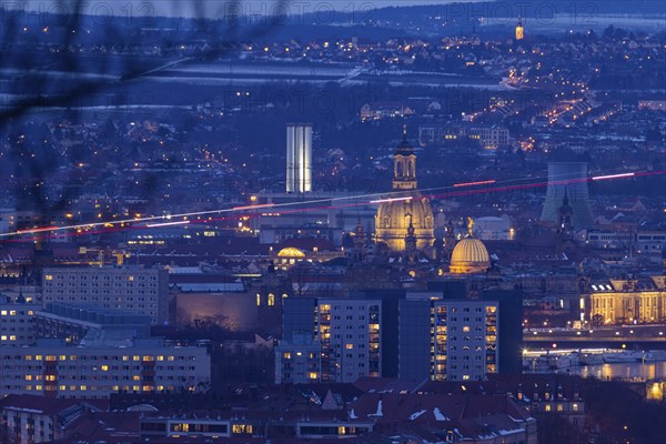 View of the old town from the Dresdner Heide in the evening: a rescue helicopter approaching the university hospital crosses the picture