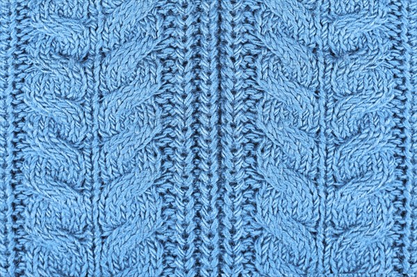 Close up of knitted pattern on blue wool pullover