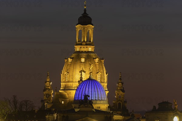 The Church of Our Lady with the glass dome over the octagon of the Academy of Arts, which is illuminated in blue in protest against the war in Ukraine