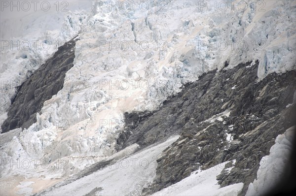 Franz Josef Glacier, Westland, New Zealand. Brown discolouration on the snow is smoke from bushfires in Australia