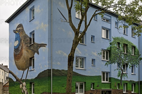 Residential buildings with a bluethroat as a mural after renovation, Bochum-Hamme, Ruhr area, North Rhine-Westphalia, Germany, Europe