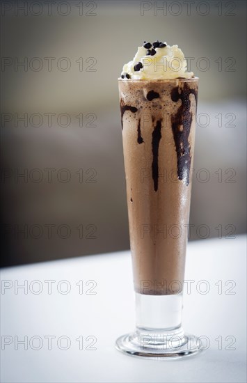 Gourmet chocolate and ice cream milkshake dessert in tall glass