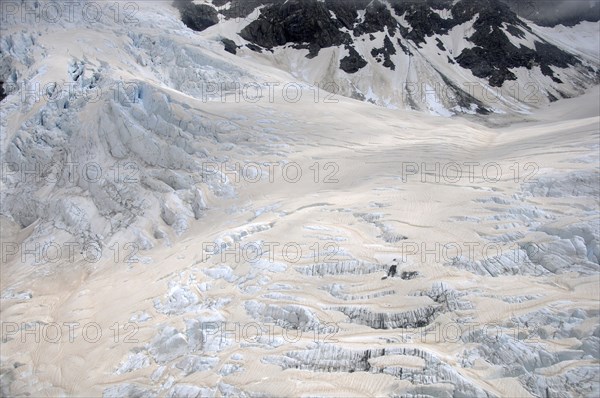 Franz Josef Glacier, Westland, New Zealand. Brown discolouration on the snow is smoke from bushfires in Australia