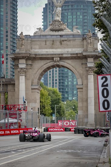 HELIO CASTRONEVES (06) of Sao Paulo, Brazil runs through the streets during the Honda Indy Toronto in Toronto, ON, CAN