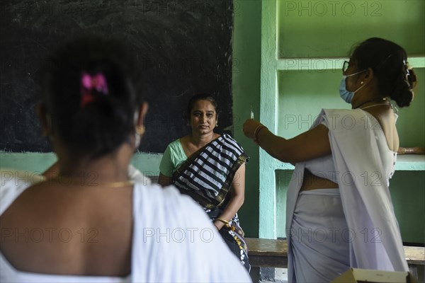 Beneficiaries receives dose of COVID-19 coronavirus vaccine in a vaccination centre at a village in Barpeta, Assam, India on 20 September 2021