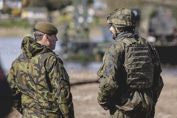 (L-R) Colonel Jiri Lila, Commander 4th Rapid Deployment Brigade, and a German army soldier talk during the military exercise 'Wettiner Schwert' near Tangermünde, 26.03.2024. 'Wettiner Schwert' is part of the Quadriga exercise of the Bundeswehr and the NATO large-scale manoeuvre Steadtfast Defender 2024