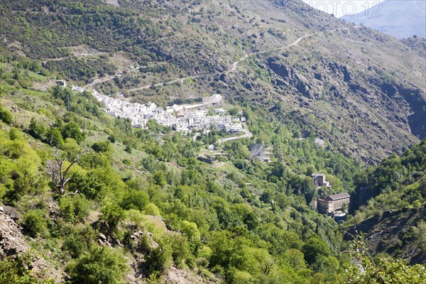 Landscape of the River Rio Poqueira gorge valley, High Alpujarras, Sierra Nevada, Granada Province, Spain whitewashed village of Pampaneria